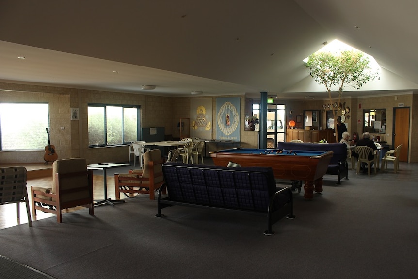 Inside the Mission to Seafarers, with pool tables, comfortable chairs, a guitar, and a skylight.