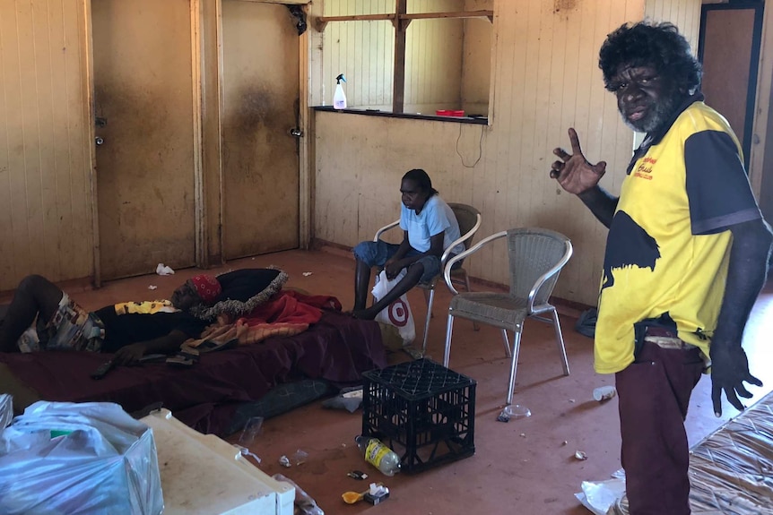 man and a woman in a rundown house