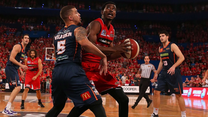 Perth Wildcats' DeAndre Daniels goes against Cairns Taipans' Scottie Wilbekin at Perth Arena.