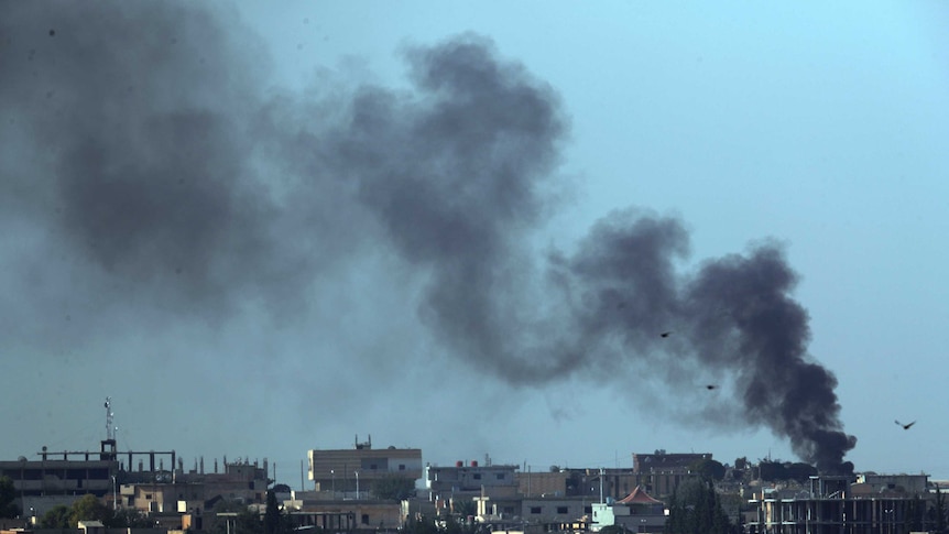 Smoke billows from targets in Tel Abyad, Syria, during bombardment by Turkish forces.