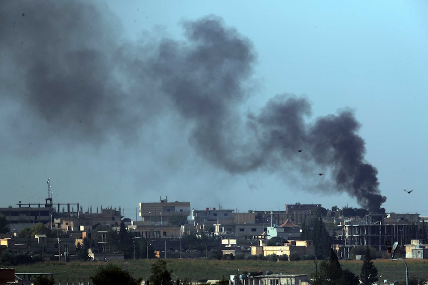 Smoke billows from targets in Tel Abyad, Syria, during bombardment by Turkish forces.