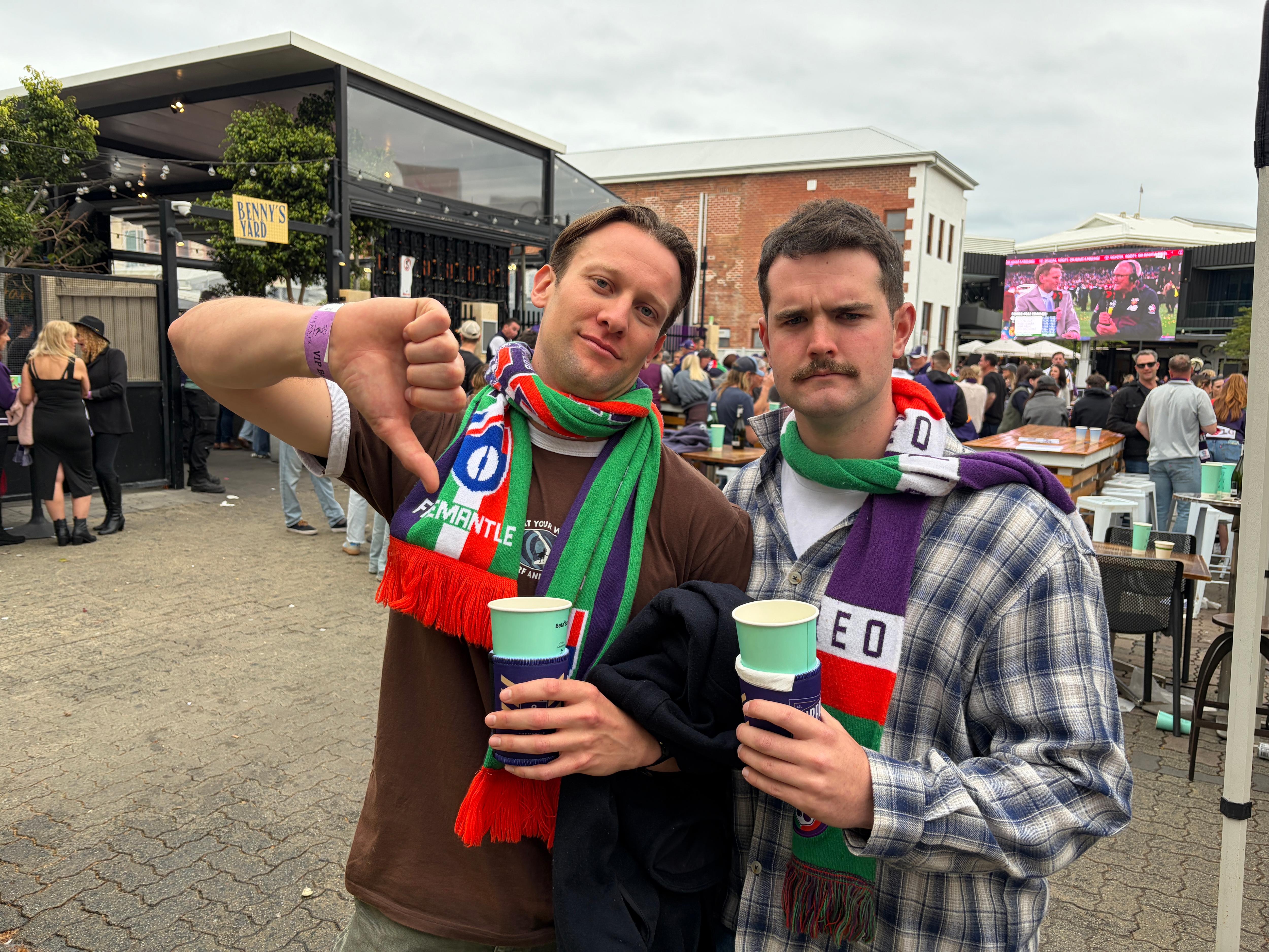Two Freo fans with an upset look. 