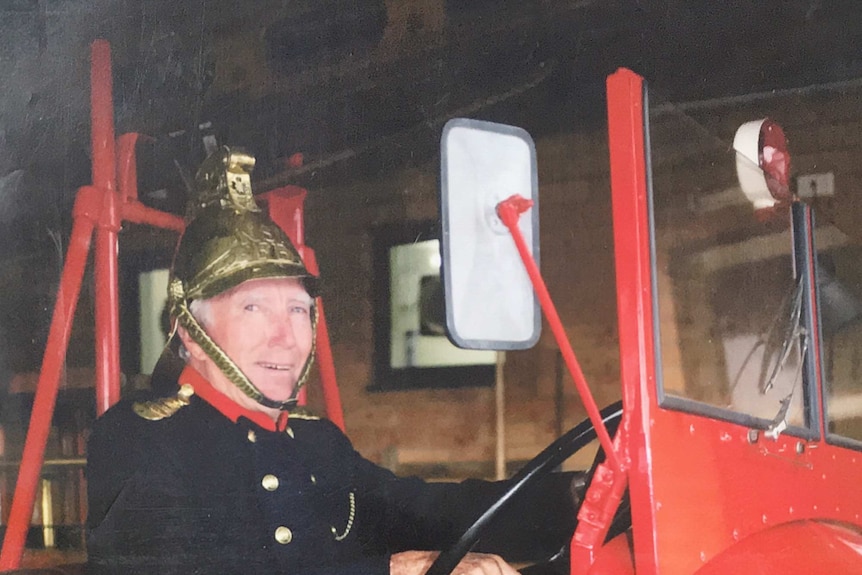 Gerry Cannon at the wheel of an antique fire truck  from the 1960's