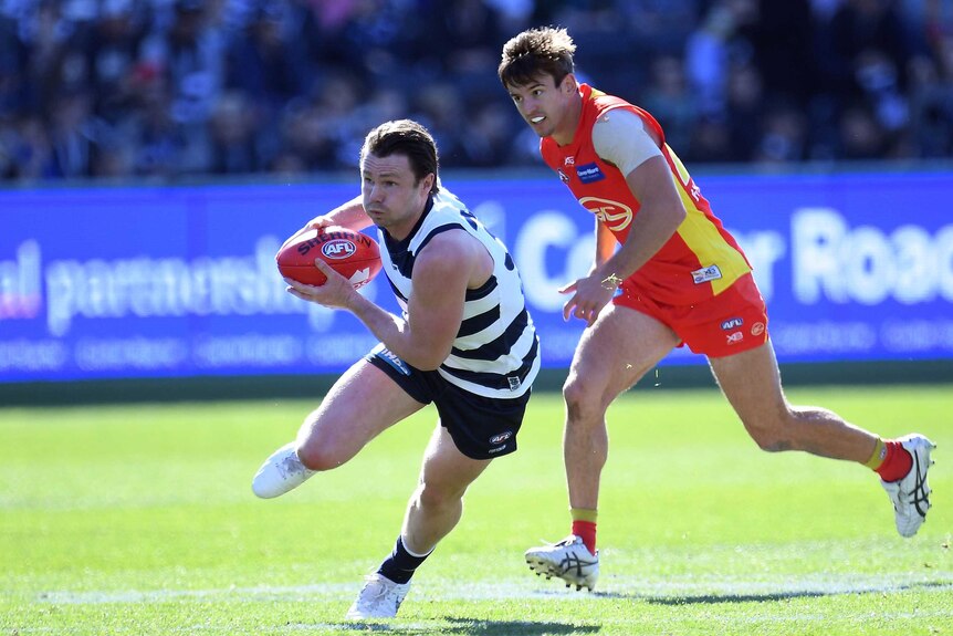 Patrick Dangerfield of the Cats (L) and Jarryd Lyons of the Suns in action at Kardinia Park.