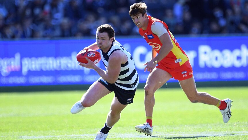Patrick Dangerfield of the Cats (L) and Jarryd Lyons of the Suns in action at Kardinia Park.