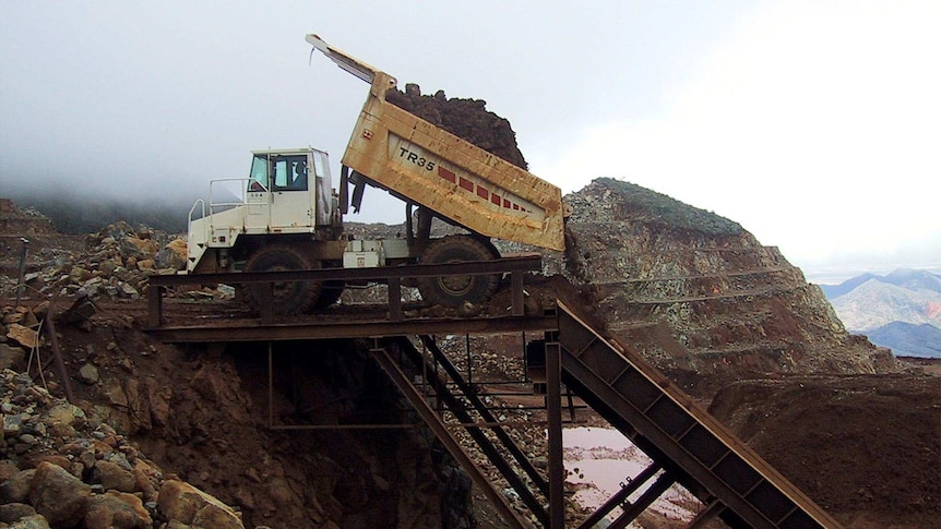 A 50-tonne truck dumps ore from New Caledonia's Ouaco nickel mine shortly before it is loaded onto freighters.