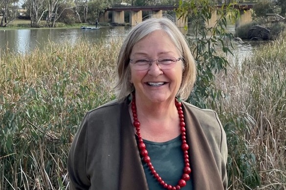 A woman standing in front of a wetlands. 