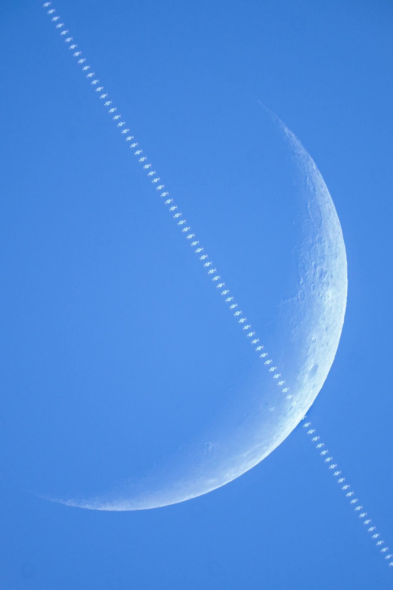 a line of ISS crossing a blue moon sliver