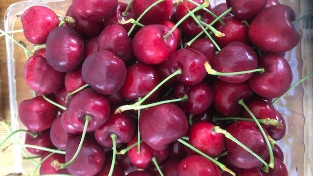 A punnet of red cherries.