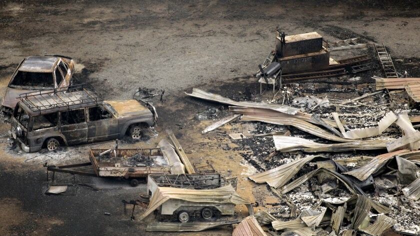 Aerial photo of a house and cars destroyed by bushfires in Kinglake
