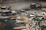 Aerial photo of a house and cars destroyed by bushfires in Kinglake