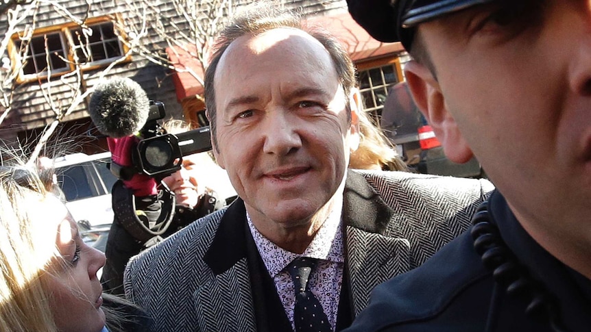 Actor Kevin Spacey arrives at district court as media crews with cameras surround him