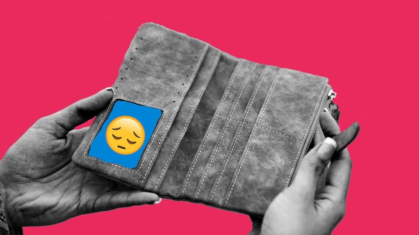 A woman opens an empty wallet for a story about why its difficult to talk about money and financial stress.