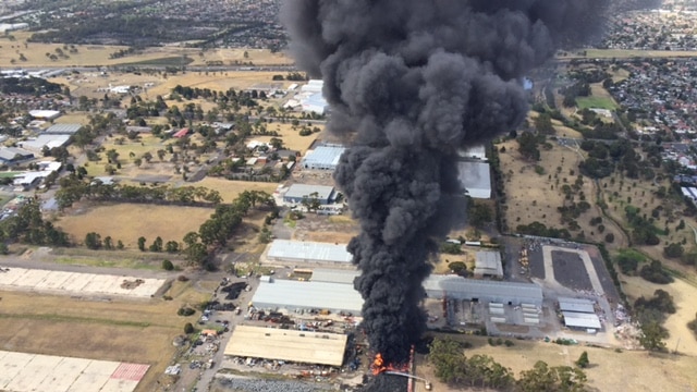 A tyre fire sends a black plume of smoke above Melbourne on January 11, 2016