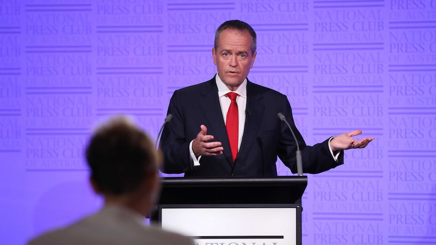 Bill Shorten stands at a National Press Club podium answering debate questions