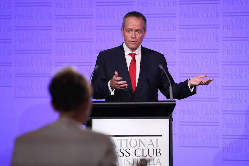 Bill Shorten stands at a National Press Club podium answering debate questions