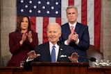 Joe Biden speaks flanked by Kamala Harris and Kevin McCarthy