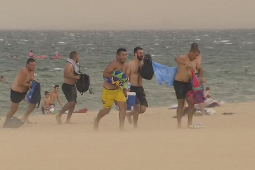 People flee from St Kilda beach to escape strong winds