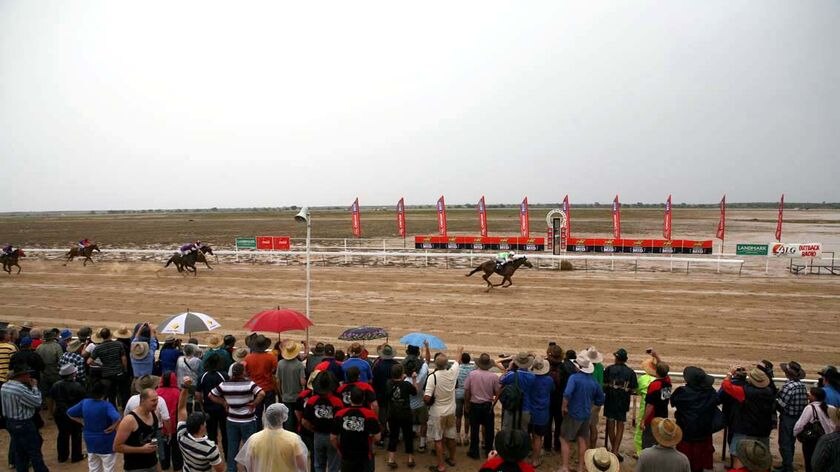 The crowd at the Birdsville Races in far west Queensland watches the finish of a race