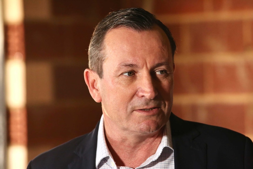 WA Premier Mark McGowan addresses a media conference wearing a suit with no tie