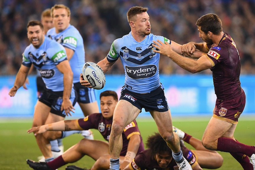 A man runs the ball during an Origin match 