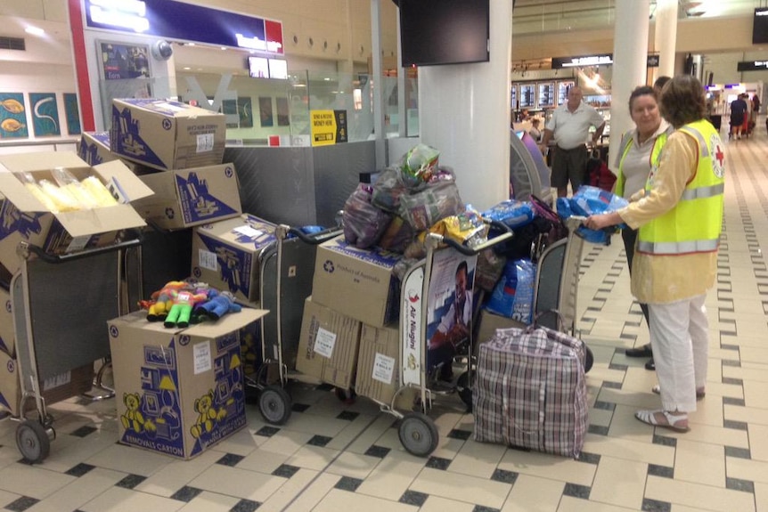 Red Cross wait at Brisbane airport with supplies for Tropical Cyclone Pam victims in Vanuatu