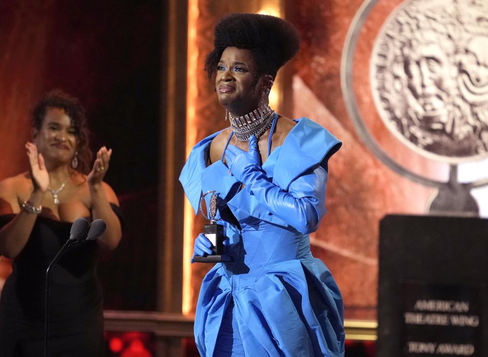 J. Harrison Ghee wearing a blue dress on stage at an awards show 