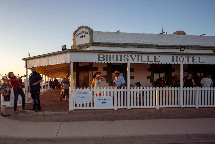 The Birdsville Hotel, packed with tourists, at sunset. 