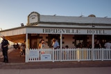 The Birdsville Hotel, packed with tourists, at sunset. 