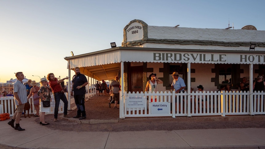 The Birdsville Hotel, packed with tourists, at sunset. 