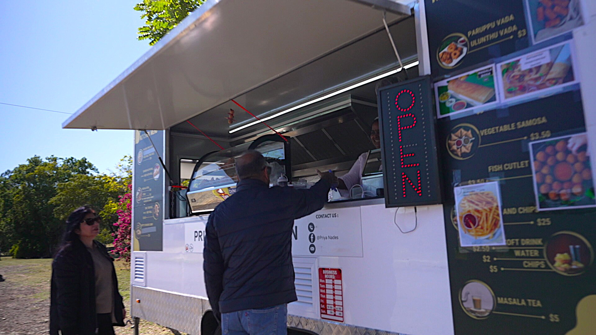 A customer shaking Priya's hand