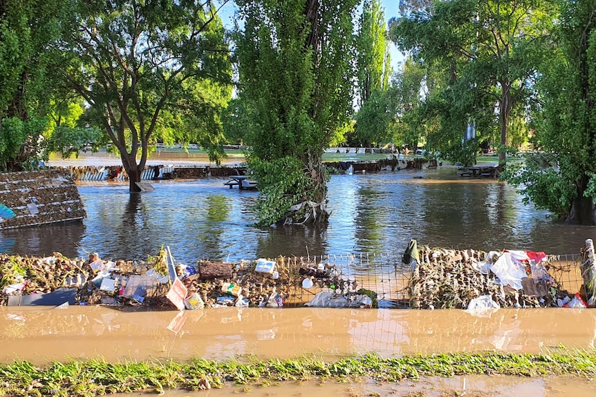 Rubbish and water fills a football oval