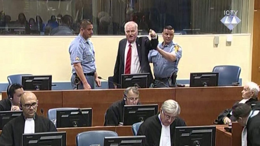 Ratko Mladic points his finger during an outburst in a tribunal.