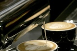 Coffee being transformed into latte art.