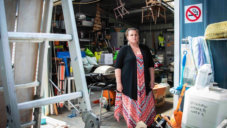 A woman standing in the shed.