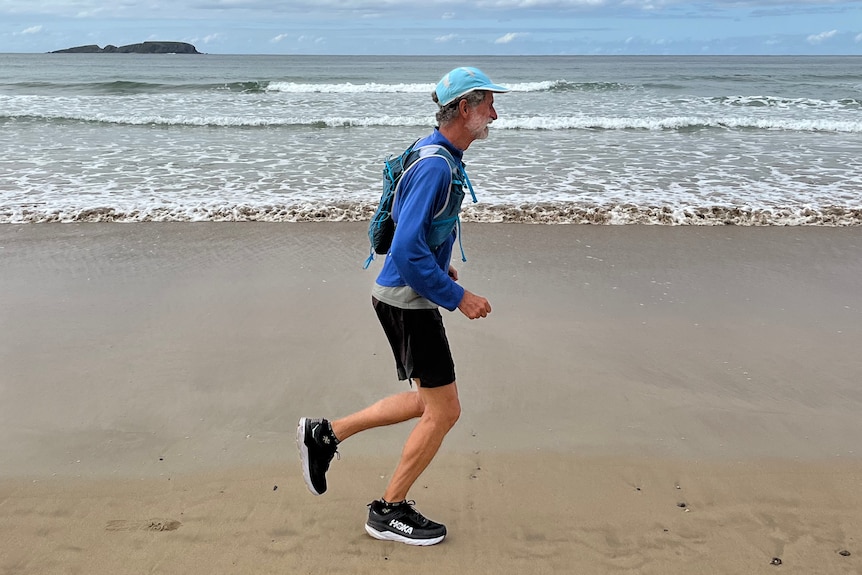 Man runs along the beach. 