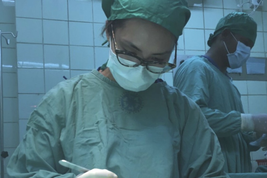 A young female surgeon in an operating theatre.