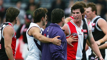 Fremantle coach Chris Connolly exchanges words with St Kilda midfielder Lenny Hayes