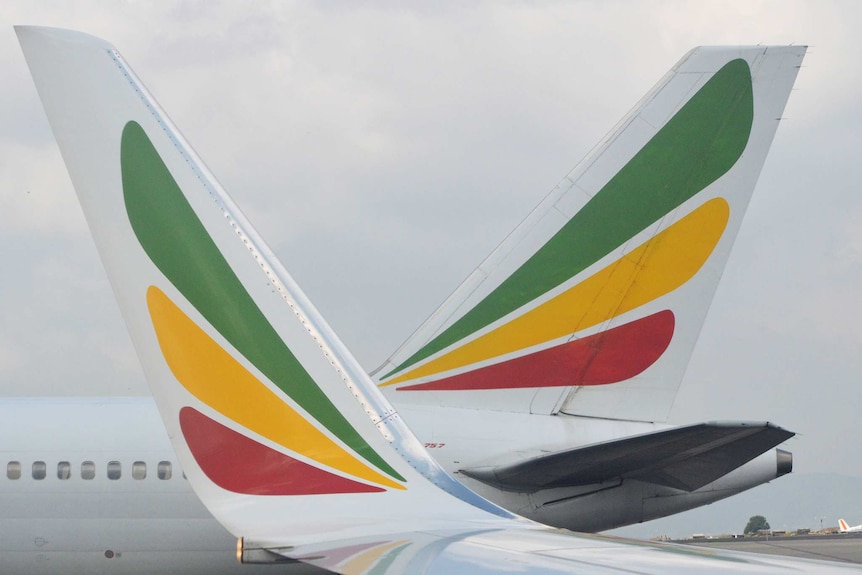 A close-up image shows two Ethiopian Airlines aircraft fins coloured in green yellow and red.