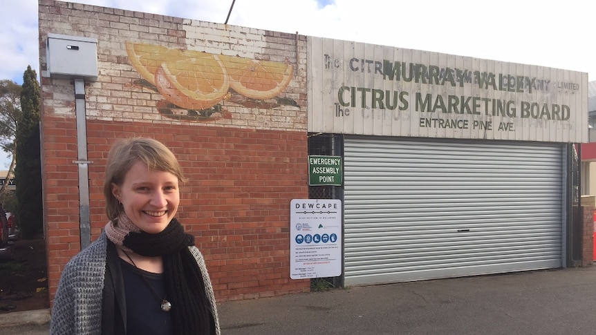 Student Claire Blainey in front of historic signs