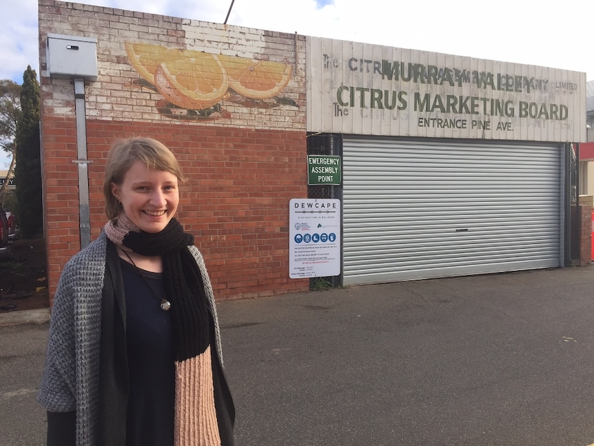 Student Claire Blainey in front of historic signs