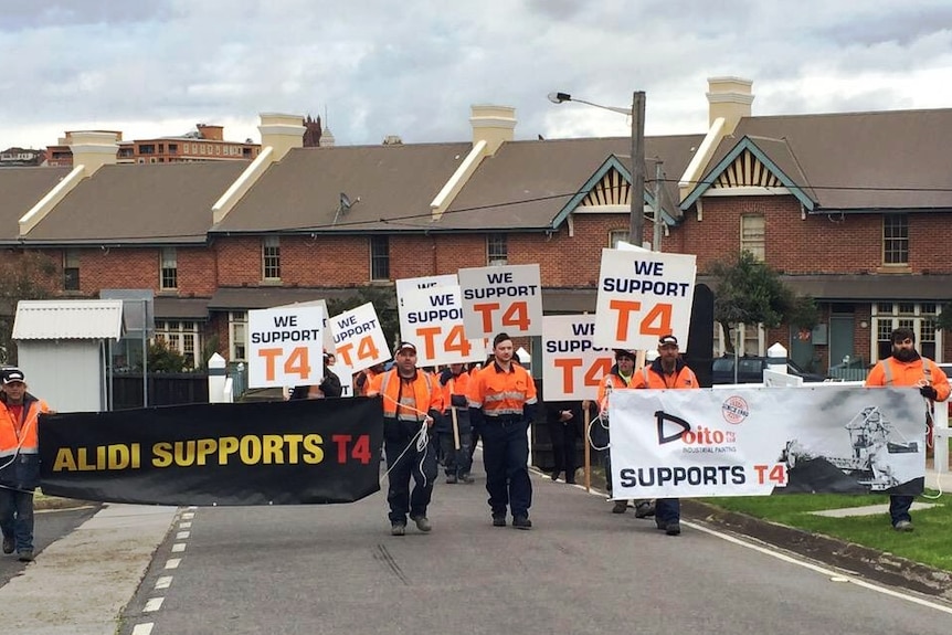 Supporters of Newcastle's T4 project rally outside a Planning Assessment Commission hearing.