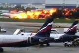 A plane lands in flame during an emergency landing.