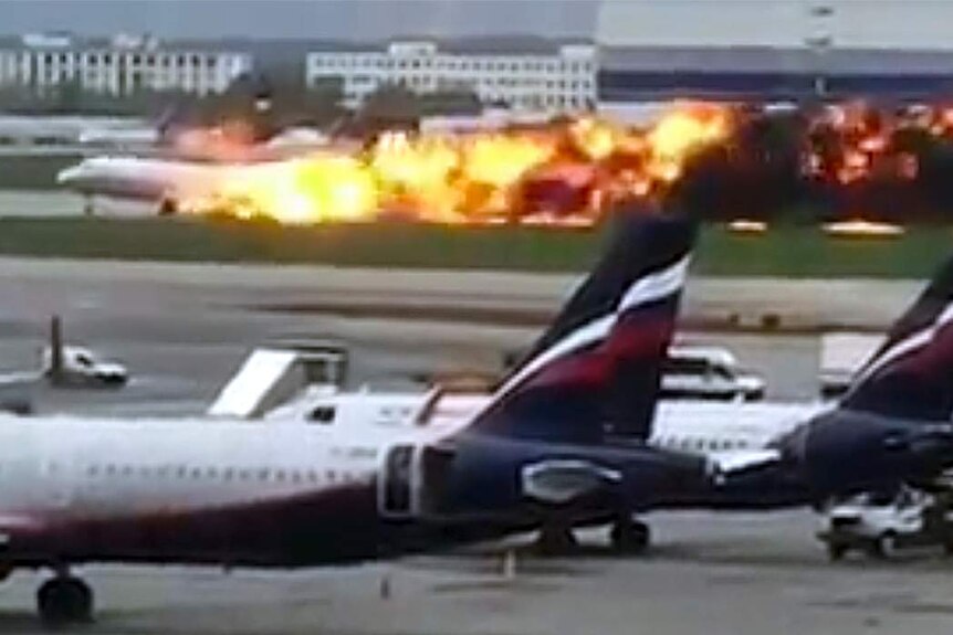 A plane lands in flame during an emergency landing.