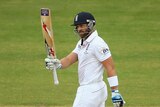 Matt Prior of England raises his bat after scoring his half century during day five of Second Ashes Test Match between Australia and England at Adelaide Oval on December 9, 2013.