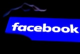 In this photo illustration a Facebook logo seen displayed on a smartphone.