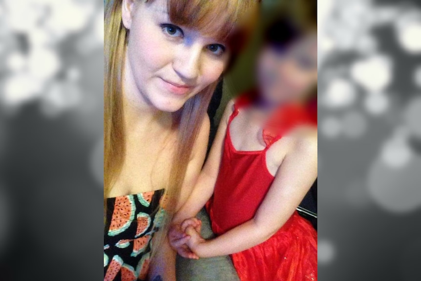 A selfie of Ashley and a child. The child's face is blurred.