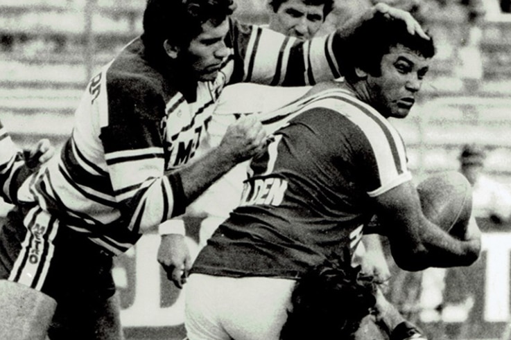 an old black-and-white picture of two men playing rugby league