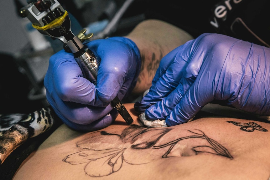 Tattoo artist offers free tattoos to cover the scars of domestic violence.