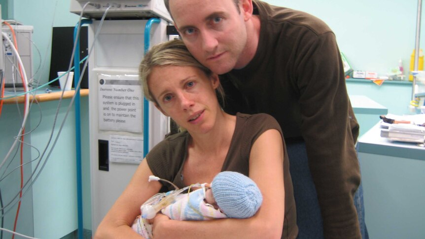 Sophie Smith cradles her baby boy, Jasper, who died 58 days after he was born. Her husband leans his head towards hers